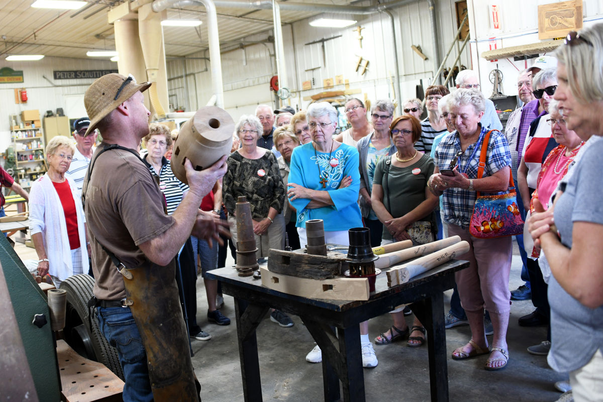 096 A worker explains how wagon wheels are constructed.JPG